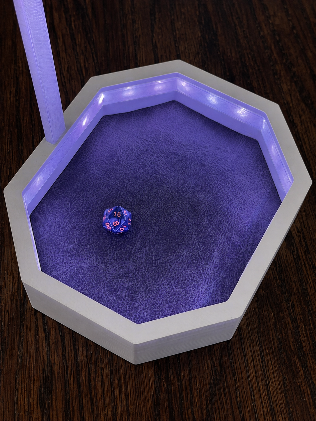Open OmniRoll Origin prototype illuminated with purple LEDs