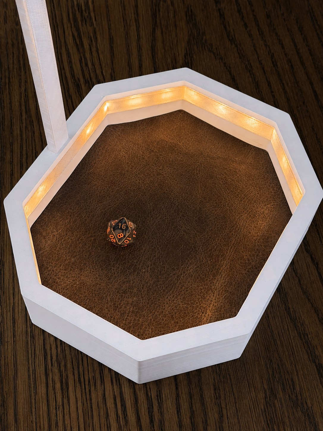 Open OmniRoll Origin prototype illuminated with warm amber LEDs